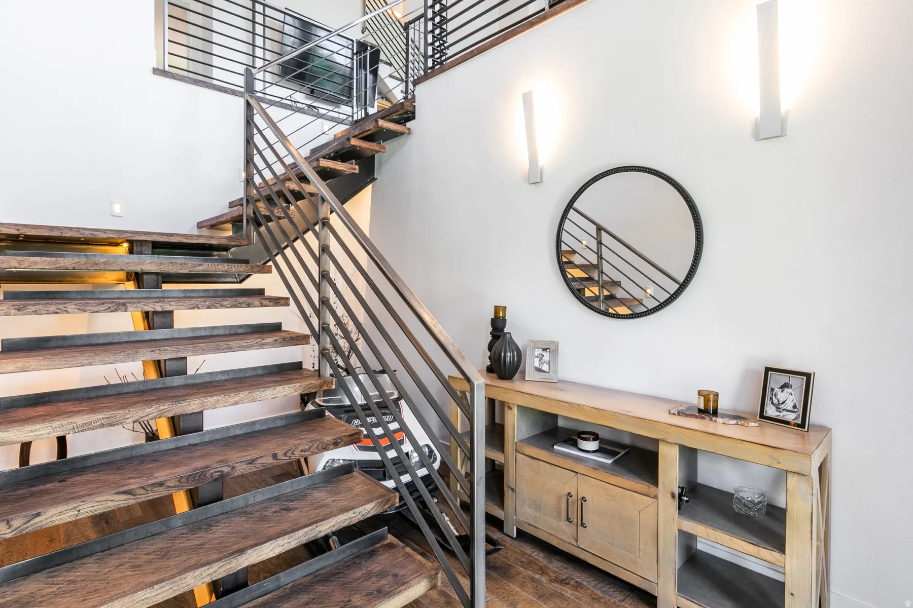 Open riser staircase featuring wood treads and metal railings