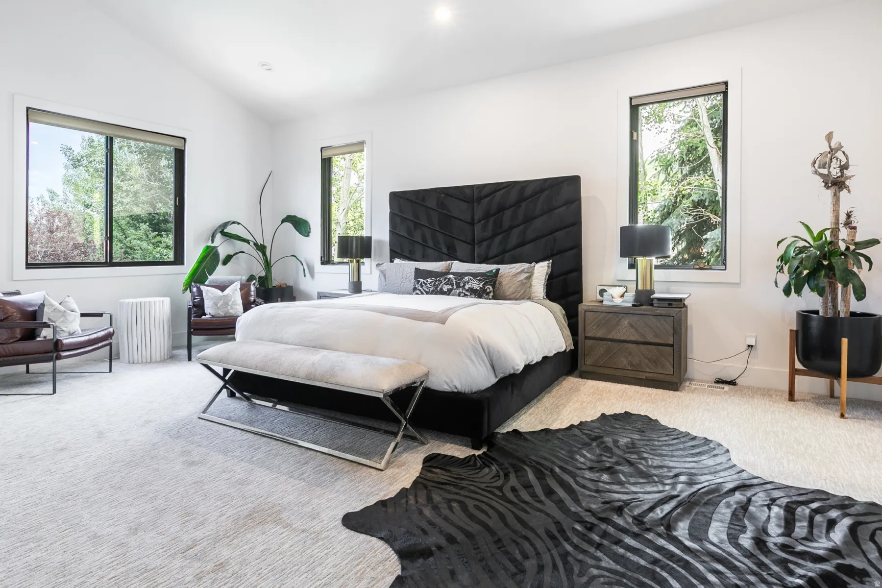 Vaulted ceilings and light-toned carpeting define this spacious room