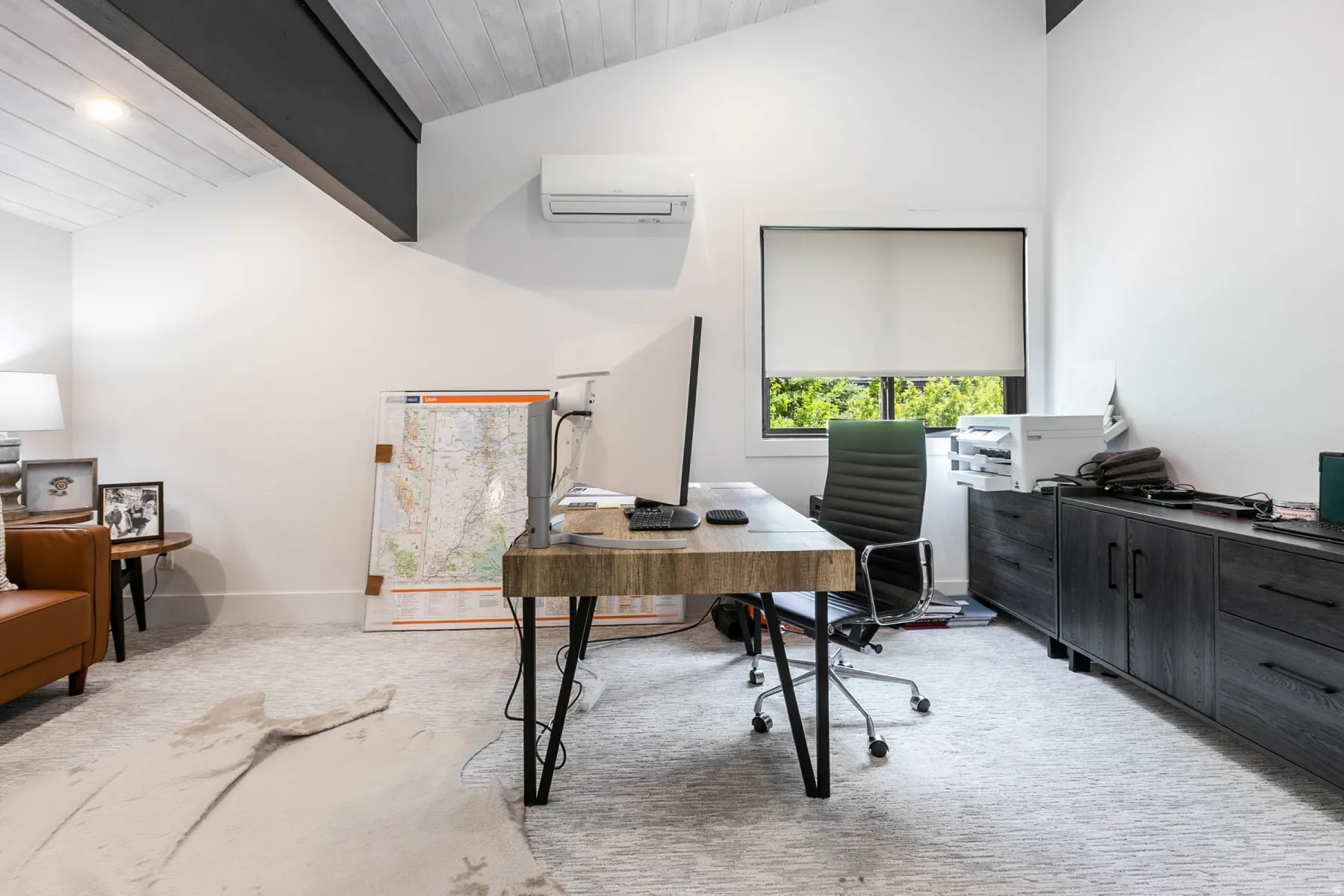 Vaulted ceiling with exposed beam, white-washed wood-finish planks, and recessed lighting