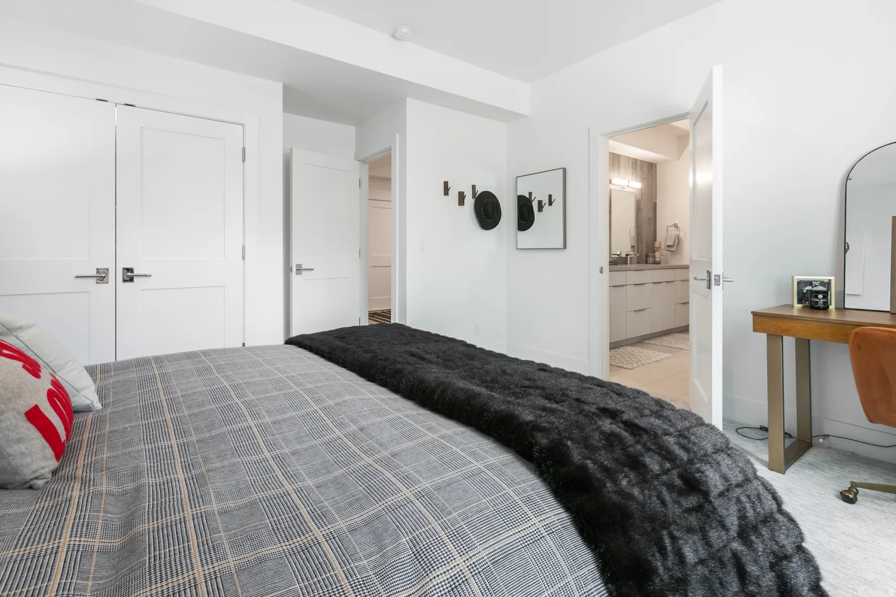 Bright room featuring white walls, white doors with brushed nickel hardware, and light-colored carpet flooring