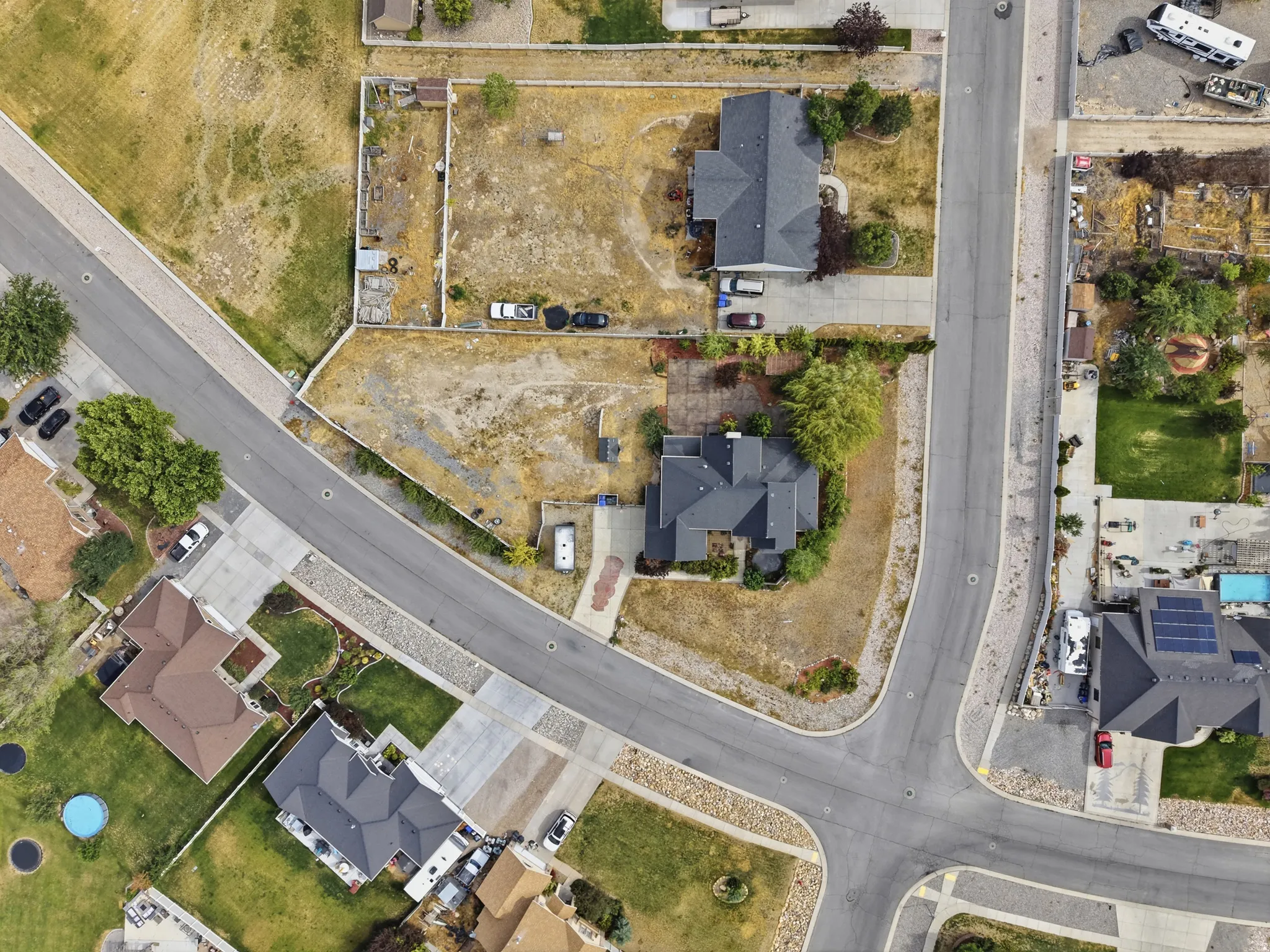 Residential neighborhood featuring established homes, paved streets, concrete driveways, and landscaped properties