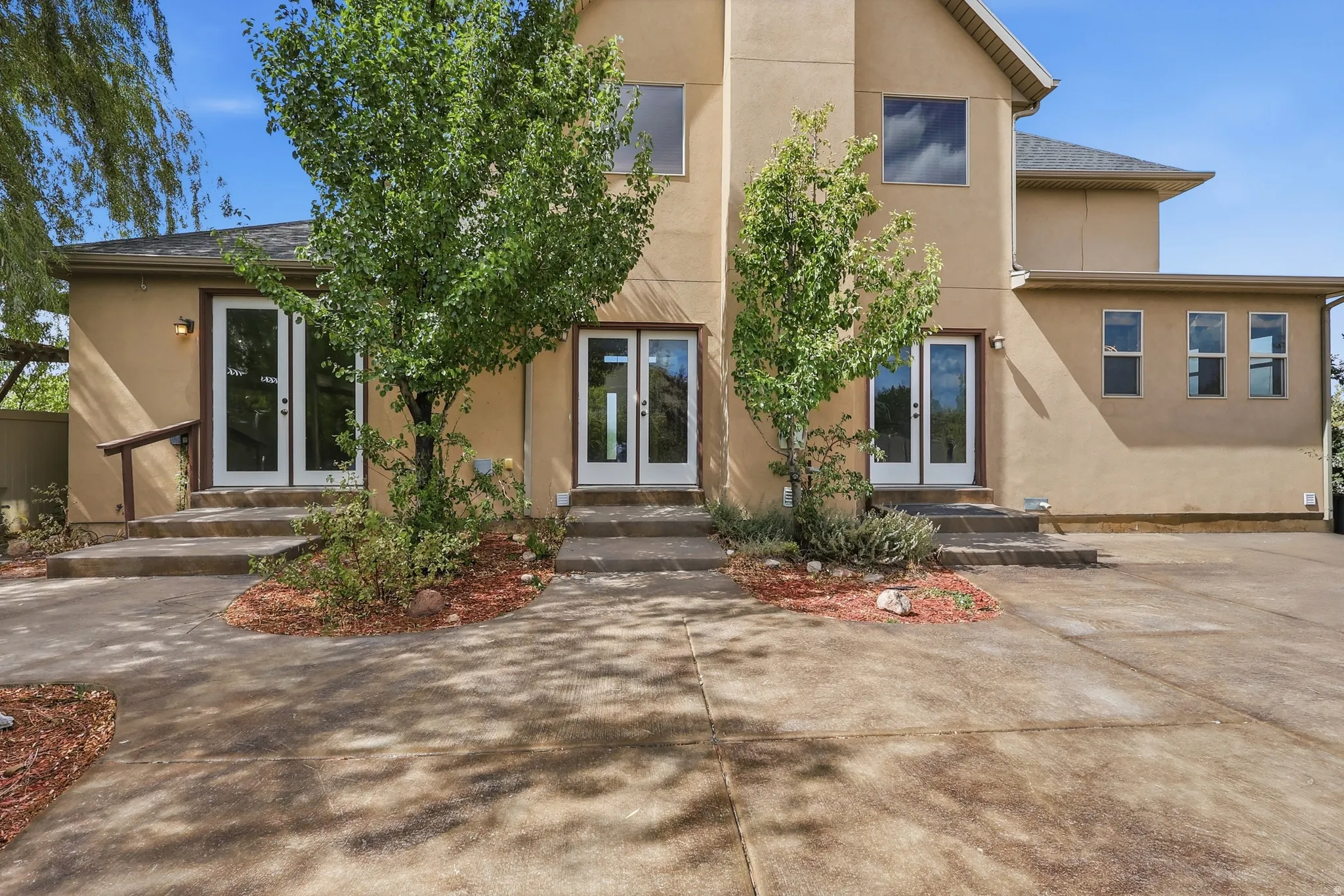 Stucco exterior with multiple double glass-panel doors