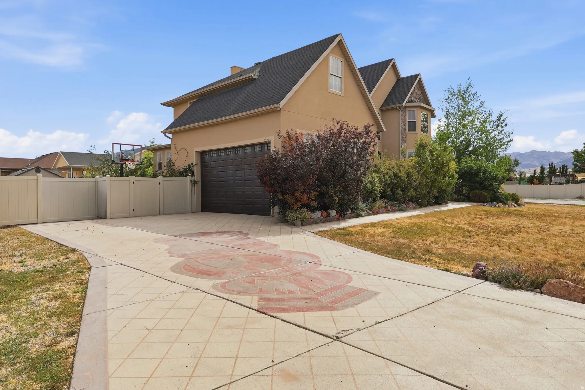 Stucco exterior residence featuring a dark asphalt shingle roof