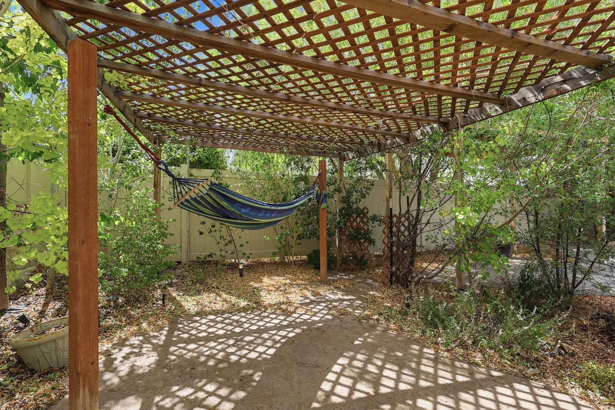 Wooden lattice pergola with a concrete patio base