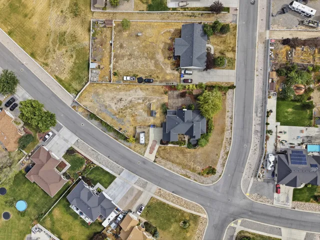 Residential neighborhood featuring established homes, paved streets, concrete driveways, and landscaped properties