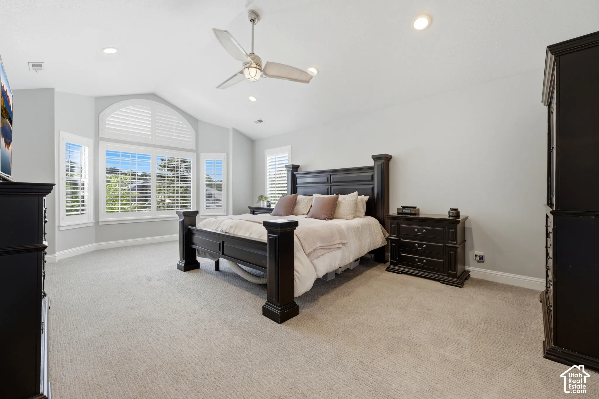 Bay window with plantation shutters and an arched transom window