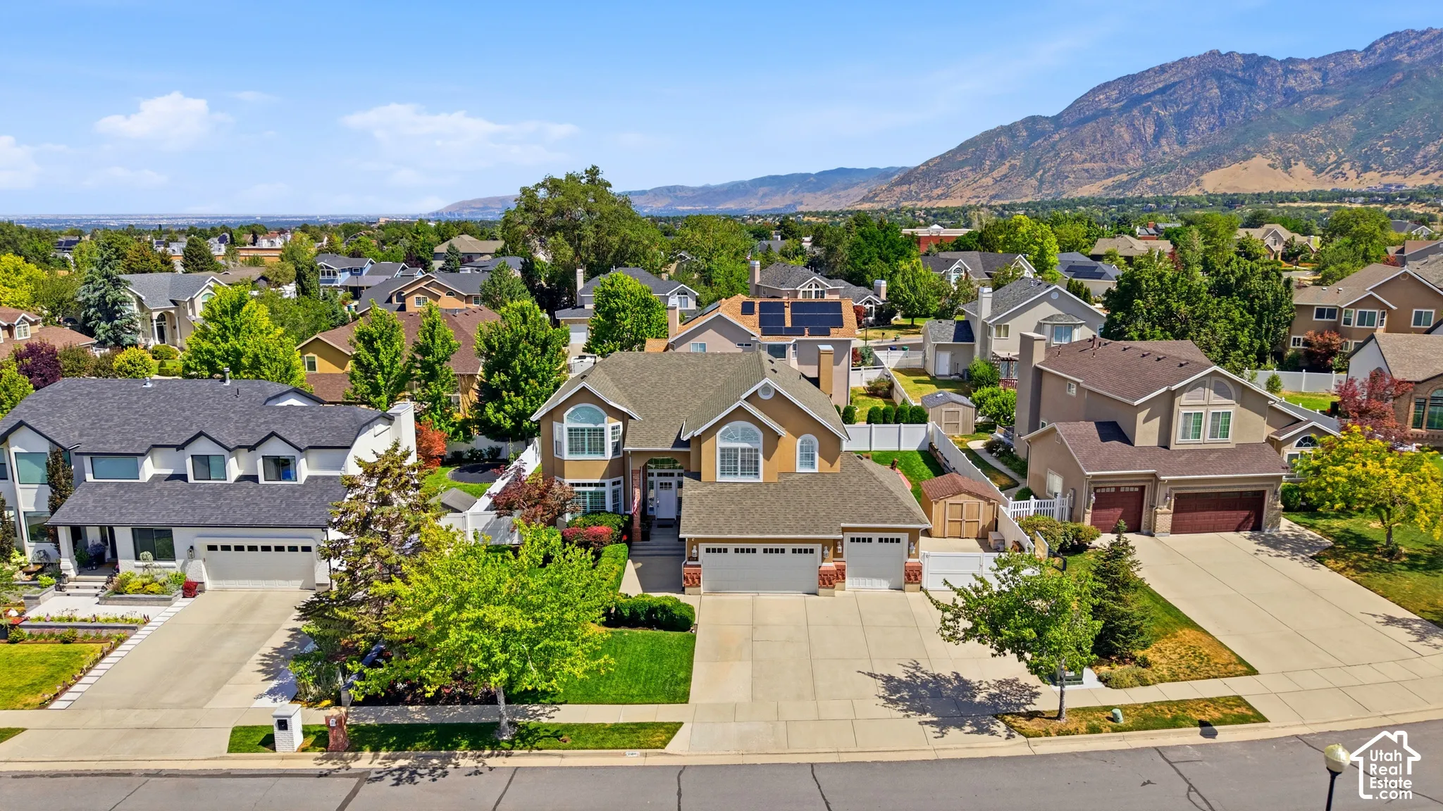 Traditional two-story residence with a tan exterior and a dark roof