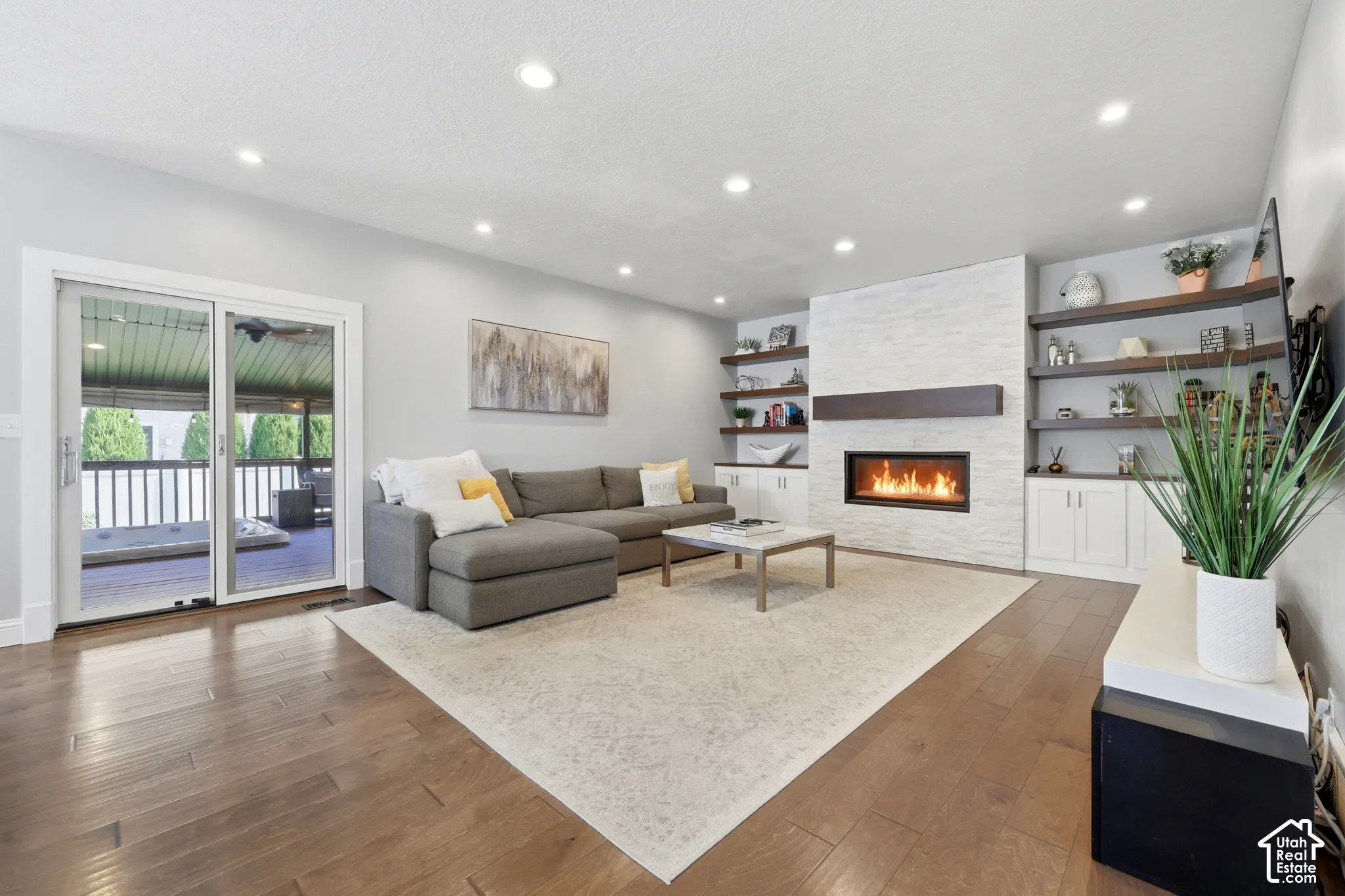 Living space featuring wood-finish flooring and recessed lighting
