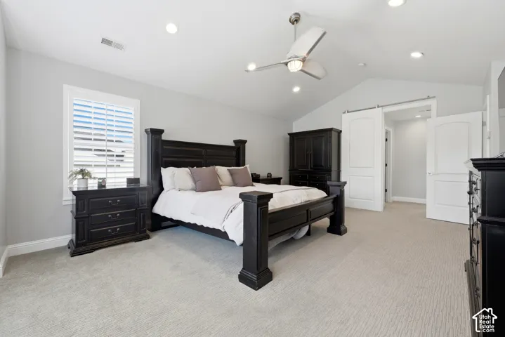 Spacious room featuring vaulted ceilings, recessed lighting, and a ceiling fan