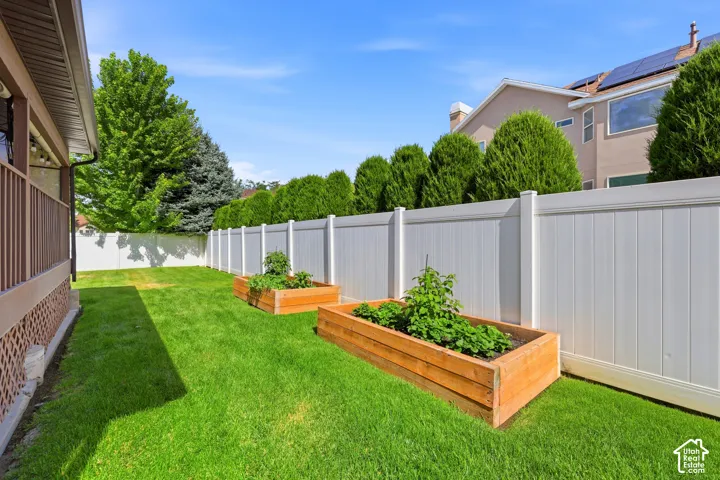 Expansive green lawn featuring two raised garden beds