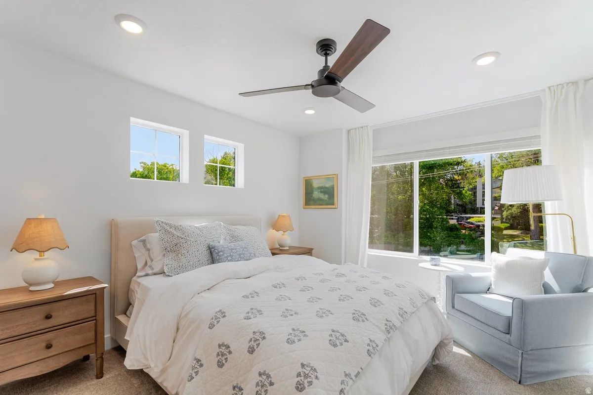 Bedroom featuring recessed lighting, a modern ceiling fan, large picture window, and two upper casement windows