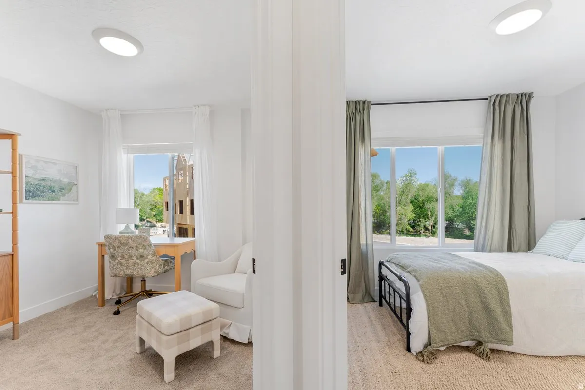 Twin bedrooms featuring large windows, flush-mount ceiling lights, and architectural white trim