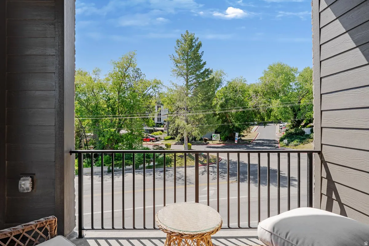 Private balcony featuring a black metal railing and durable siding
