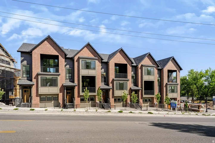 Contemporary townhome facade featuring brick and siding accents