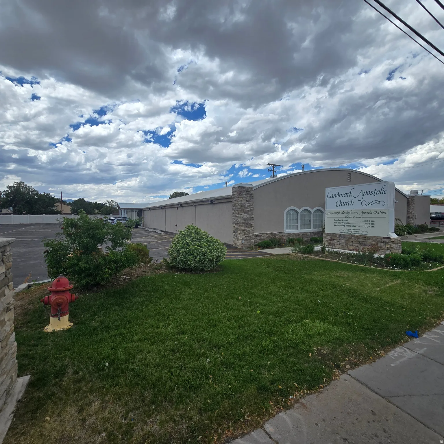 Commercial building featuring a stucco exterior with stone accents and arched windows