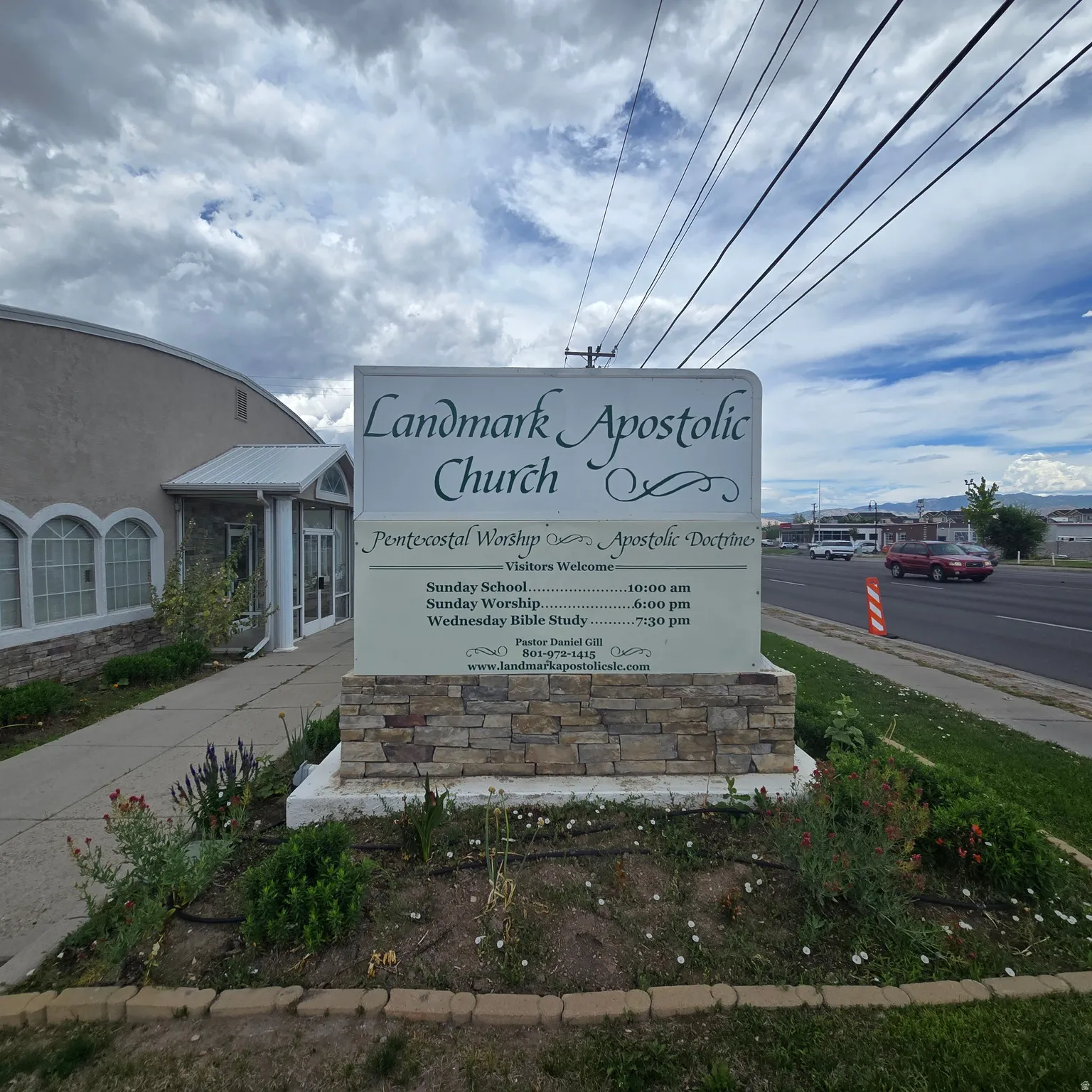 Freestanding monument sign with stone veneer base and informational display