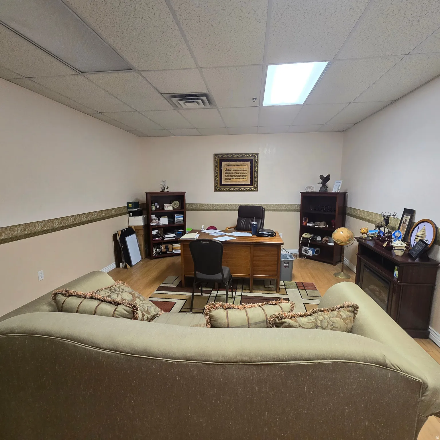 Spacious room with a drop ceiling featuring recessed lighting