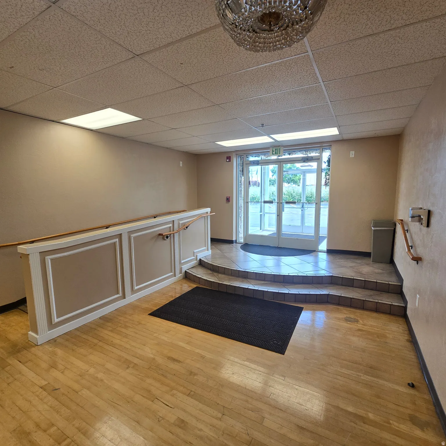 South side entry with doupbel doors, step and access ramp.