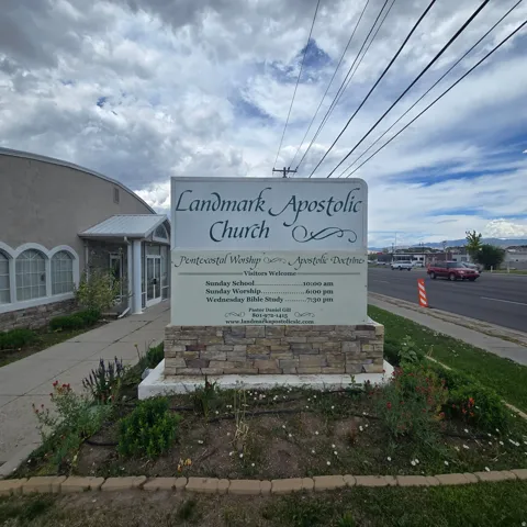 Freestanding monument sign with stone veneer base and informational display