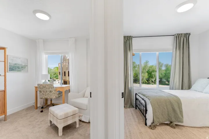 Twin bedrooms featuring large windows, flush-mount ceiling lights, and architectural white trim