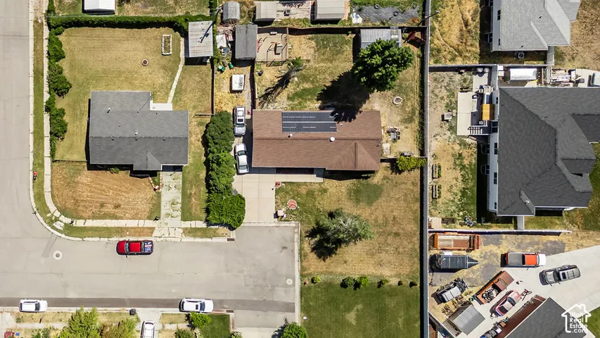 Single-story residence featuring a brown shingle roof with solar panels