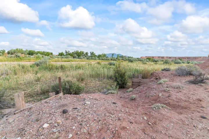 Expansive land parcel featuring natural desert vegetation, varied terrain, and distant tree lines under a broad sky