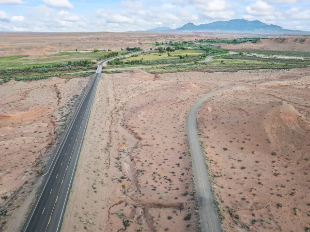 Expansive desert landscape with two distinct roads traversing the terrain