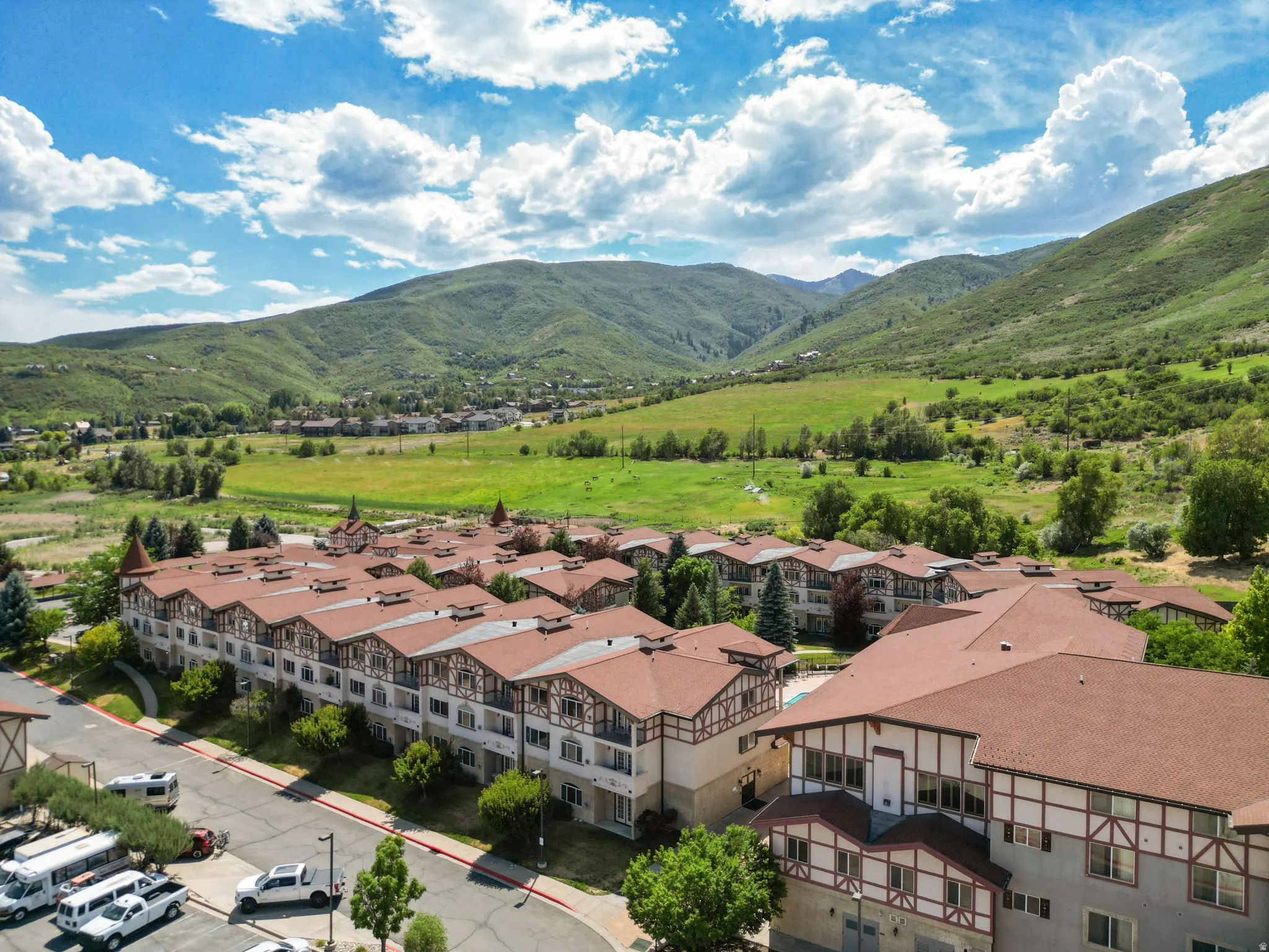 Multi-story residential buildings with pitched brown roofs and timber frame detailing
