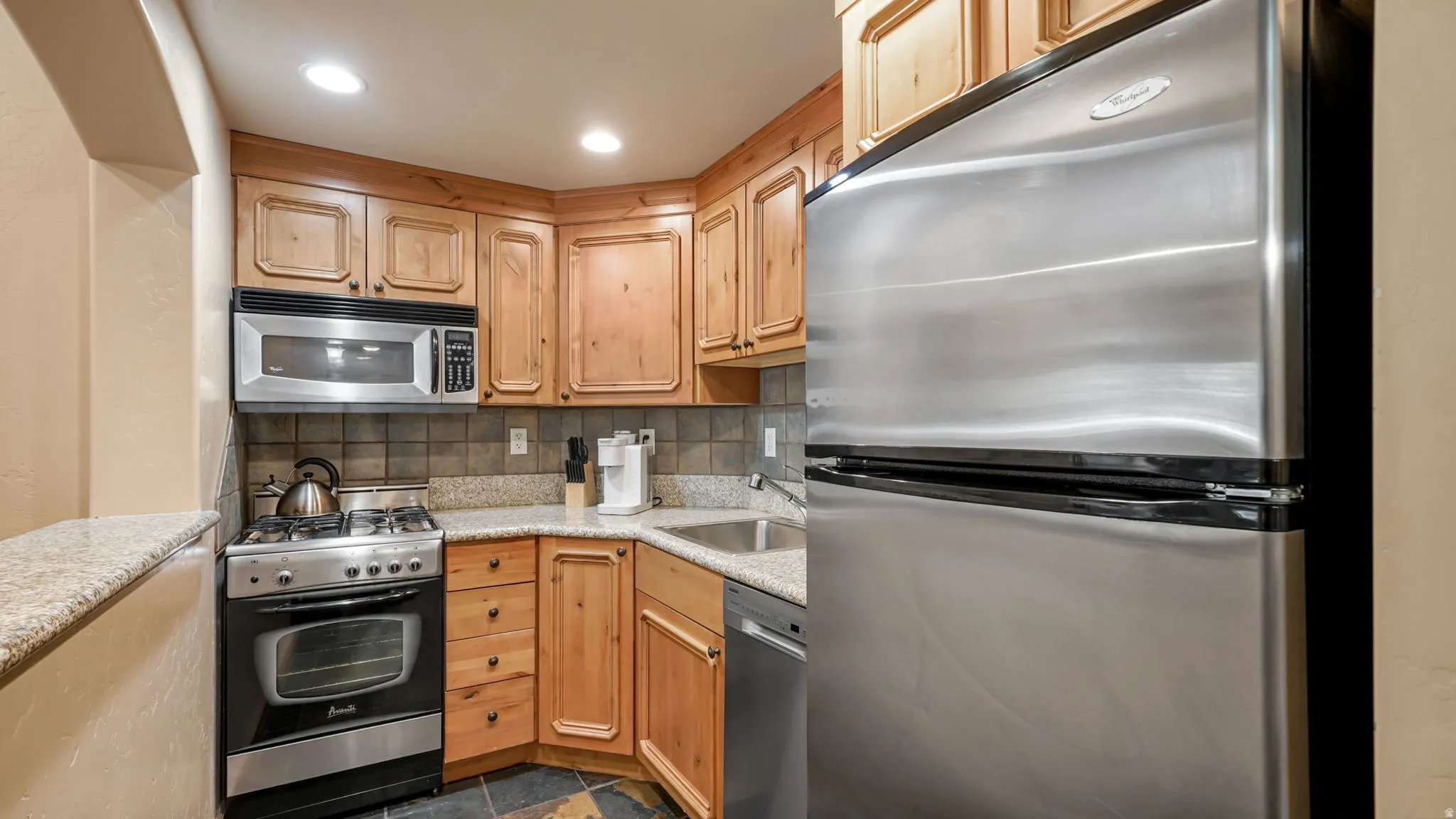 Kitchen featuring stainless steel appliances and wood-finish cabinetry