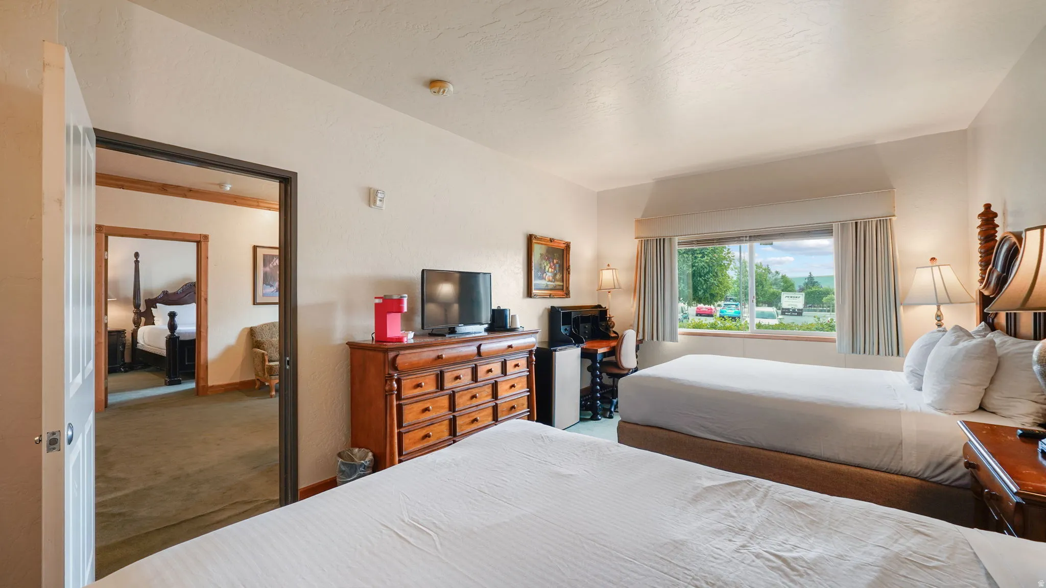 Bright 2nd bedroom featuring two beds and a large window, offering ample natural light and lock out access to main living
