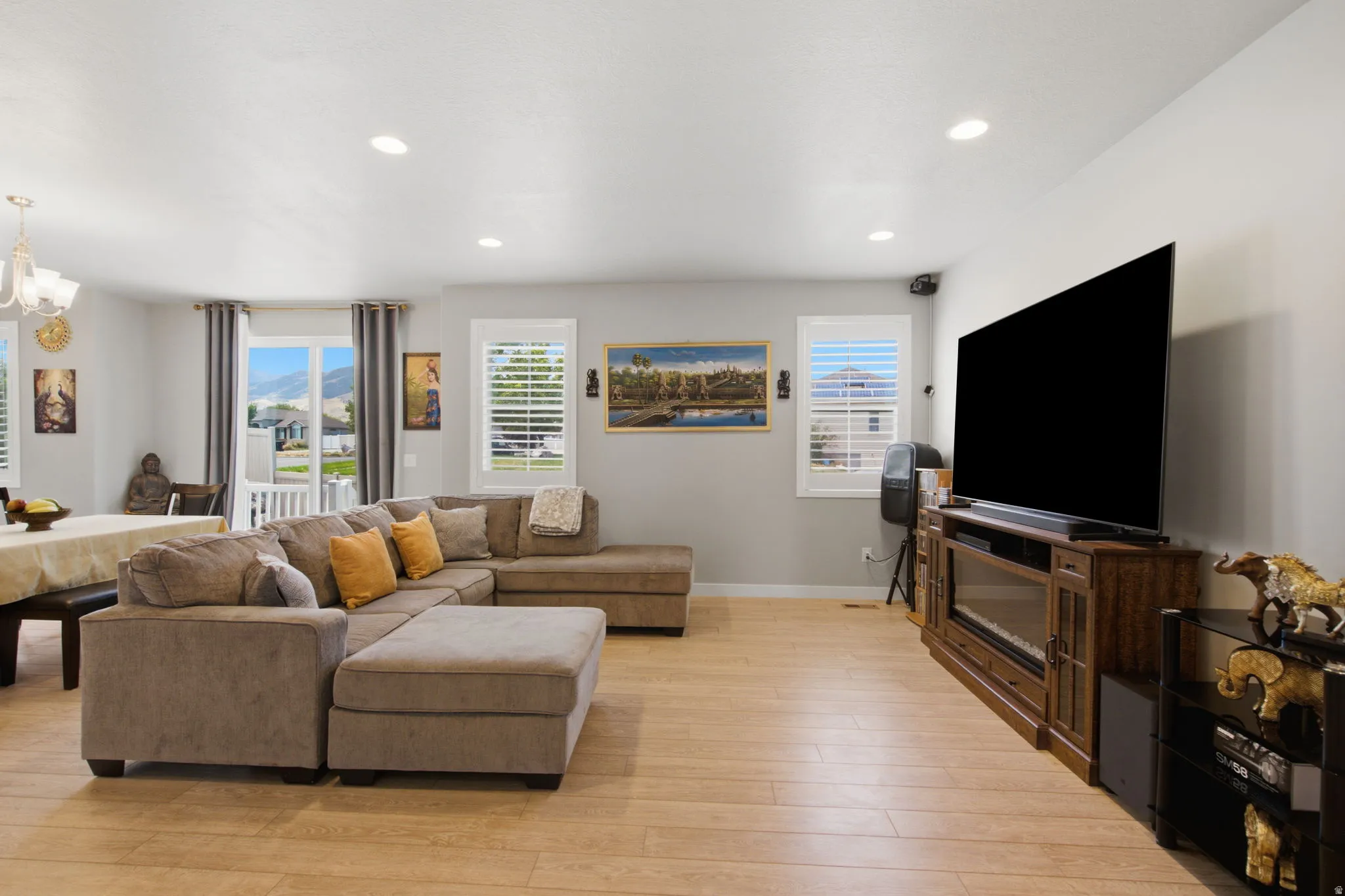 Open-concept living area featuring light wood-finish flooring and recessed lighting