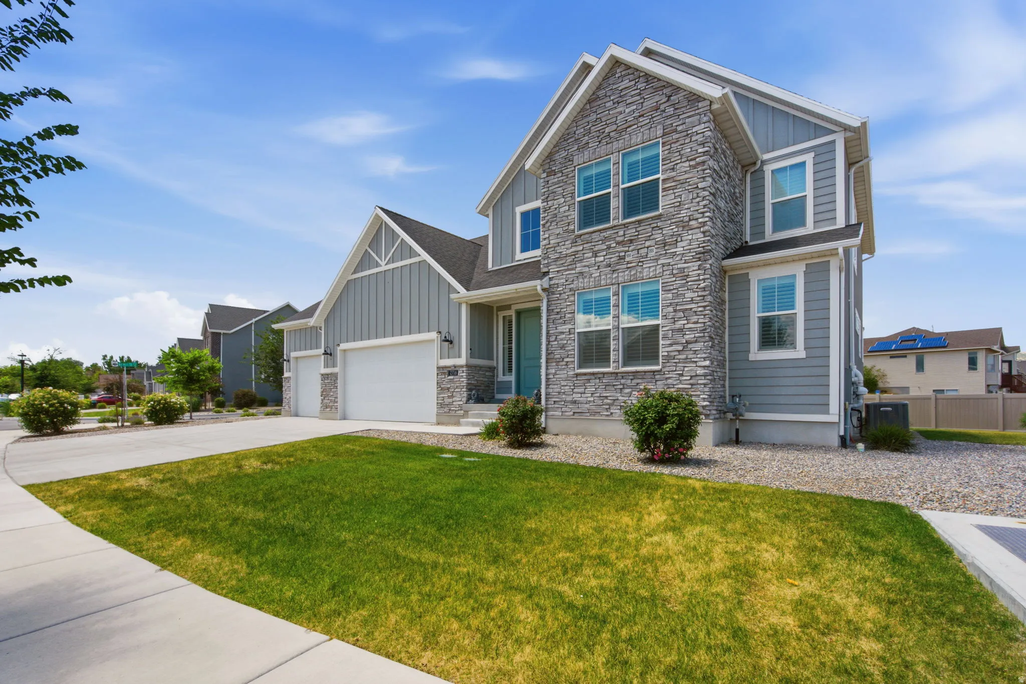 Contemporary two-story exterior featuring a stone and siding facade