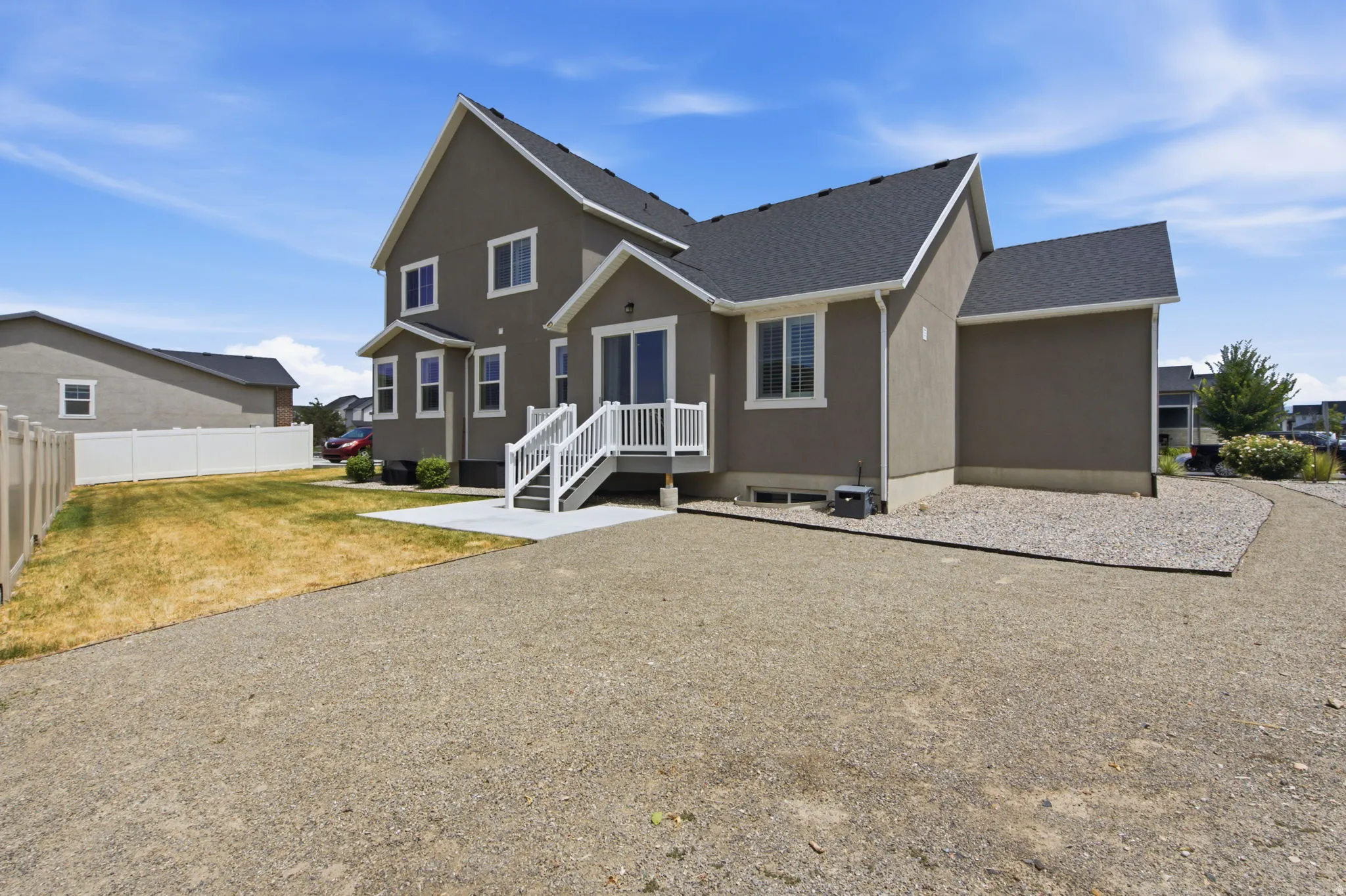 Two-story residence featuring a gray exterior and white trim