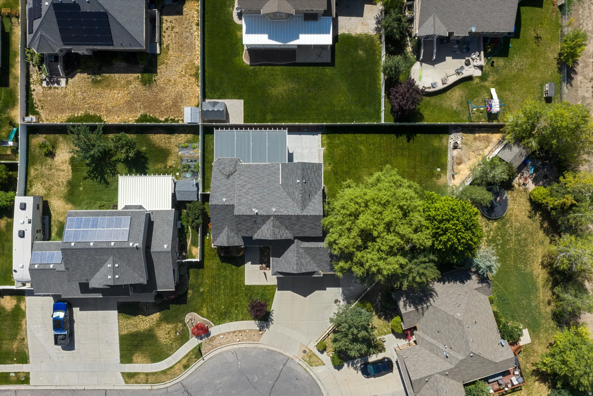 Aerial perspective showcasing a residential property with a multi-gabled roof and an attached garage