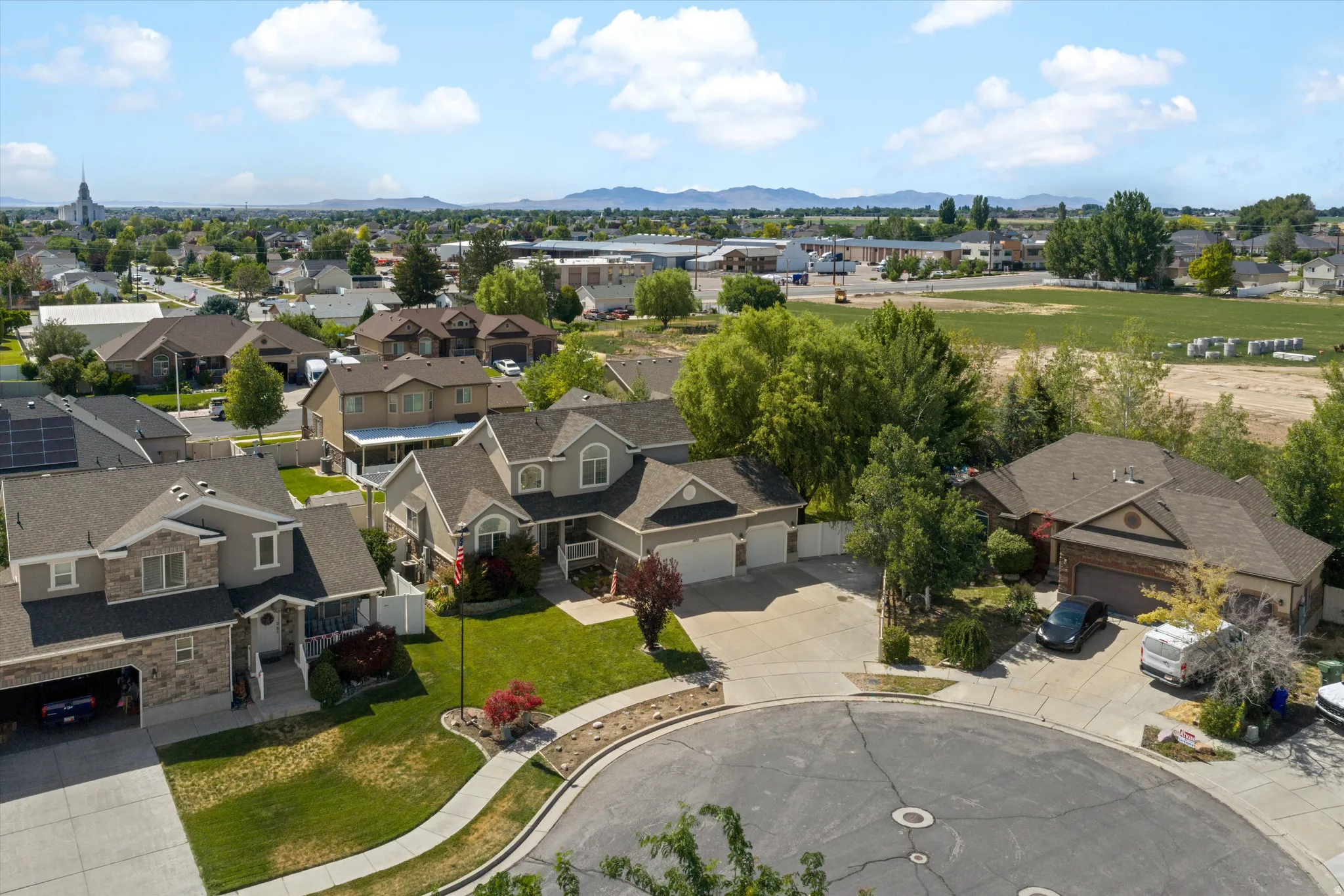 Spacious cul-de-sac property featuring a two-story residence with an attached three-car garage
