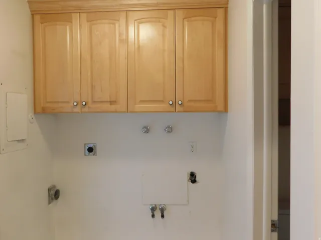 Upper cabinetry with light wood finish and crown molding detail