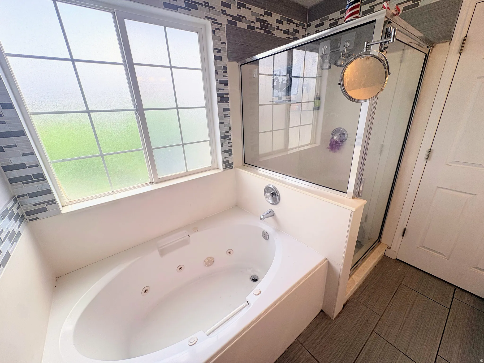 Soaking tub with a full-size window and privacy glass