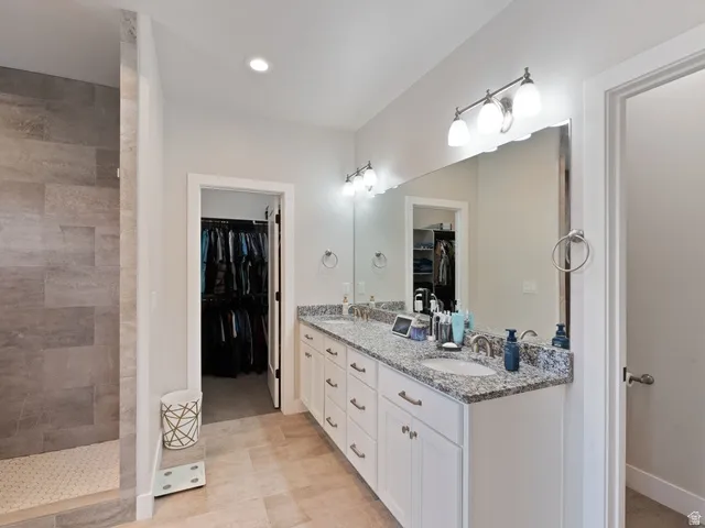 Double vanity with granite countertops, undermount sinks, and brushed nickel fixtures