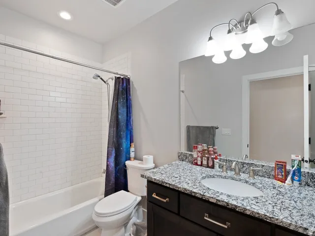 Bathroom featuring a white subway tile shower surround and a tub
