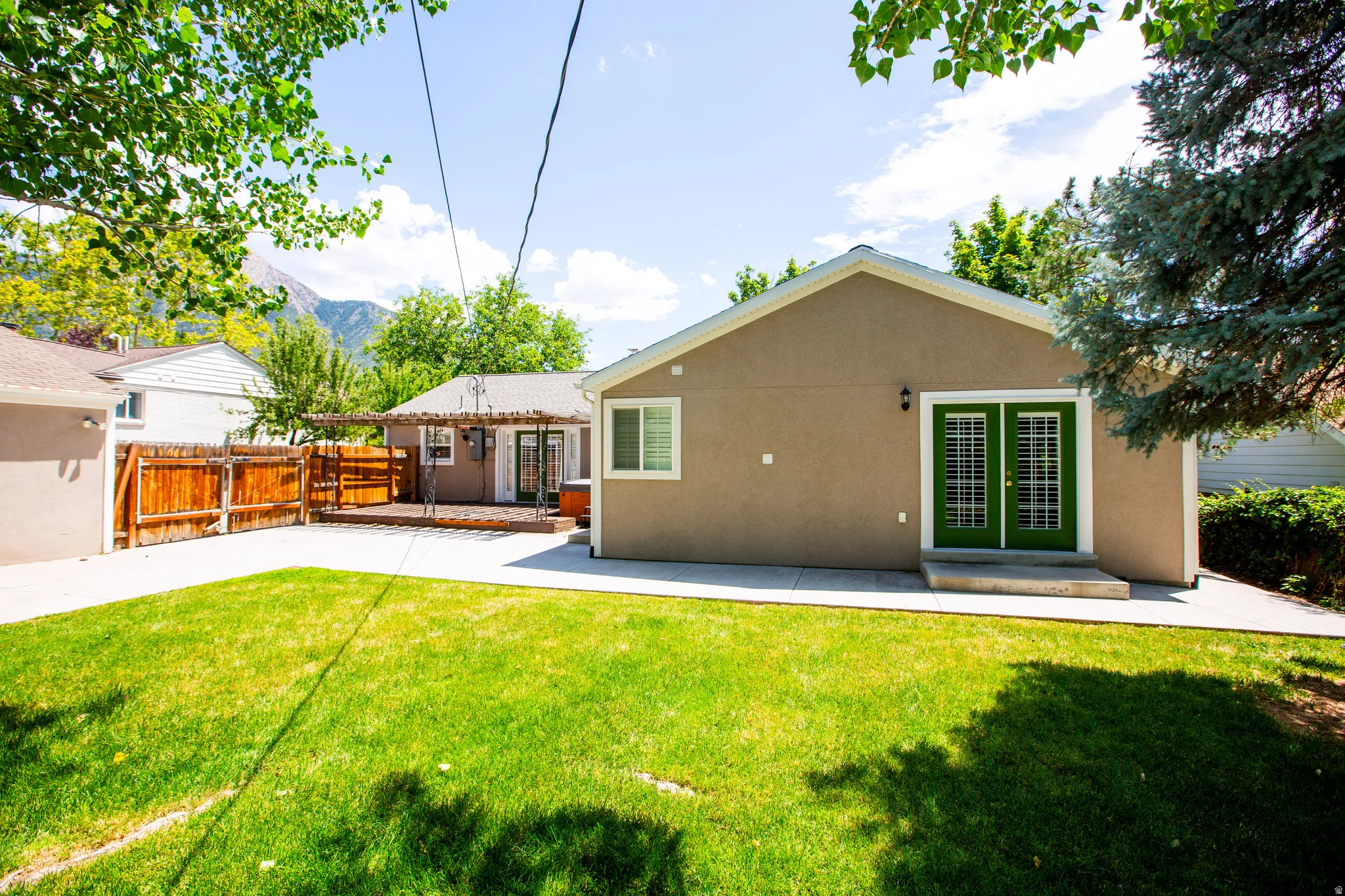 Expansive green lawn with concrete patio and pathways