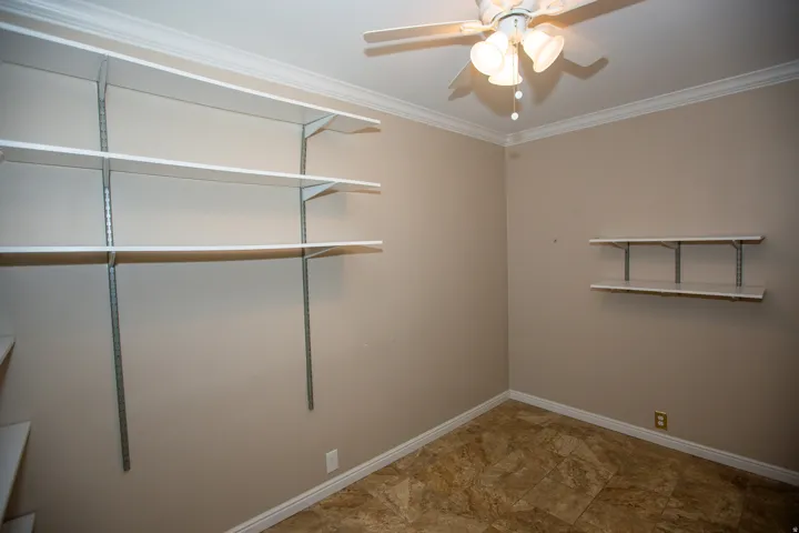Storage/Office with neutral tone wall paint with white crown molding
