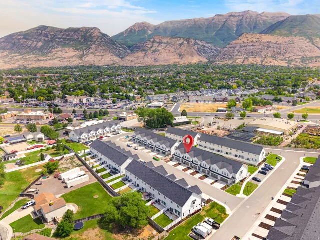 Rows of modern townhomes featuring white facades and dark roofs