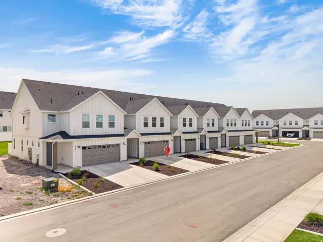 Newly constructed townhome community featuring modern farmhouse architectural style