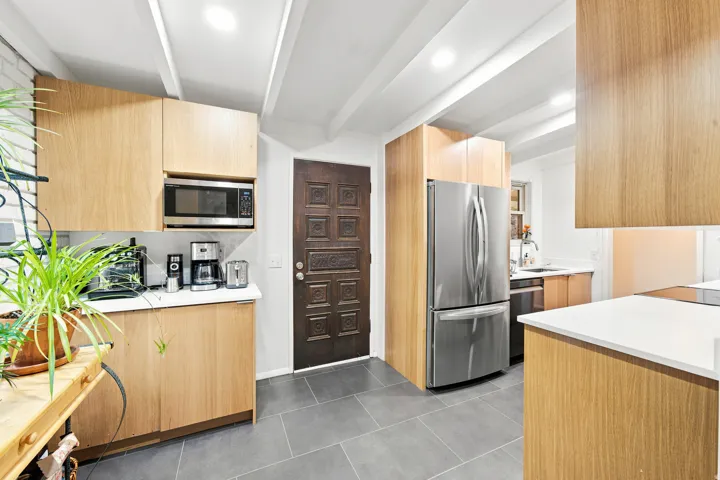 Kitchen featuring light wood-finish cabinetry, stainless steel appliances, white countertops, and recessed lighting