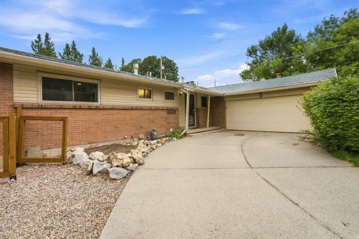 Brick and siding exterior with an attached garage and a concrete driveway