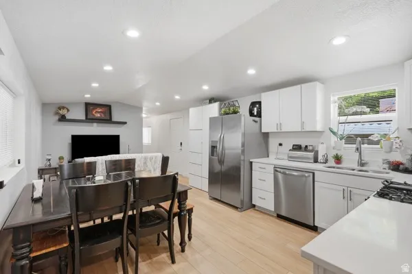 Open-concept living space featuring light wood-finish flooring and recessed lighting