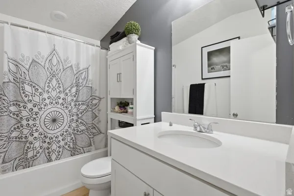 Bathroom featuring a single vanity with an integrated sink and chrome faucet