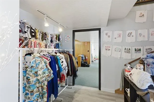 Interior space featuring light gray walls, track lighting, and wood-finish flooring