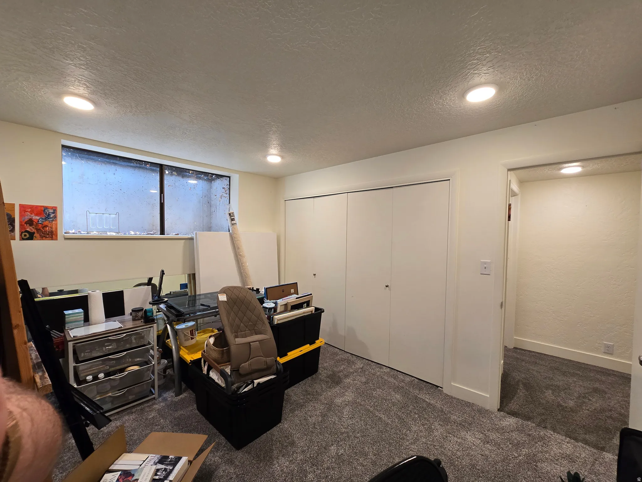 Room featuring a large window, neutral paint, recessed lighting, and grey carpet