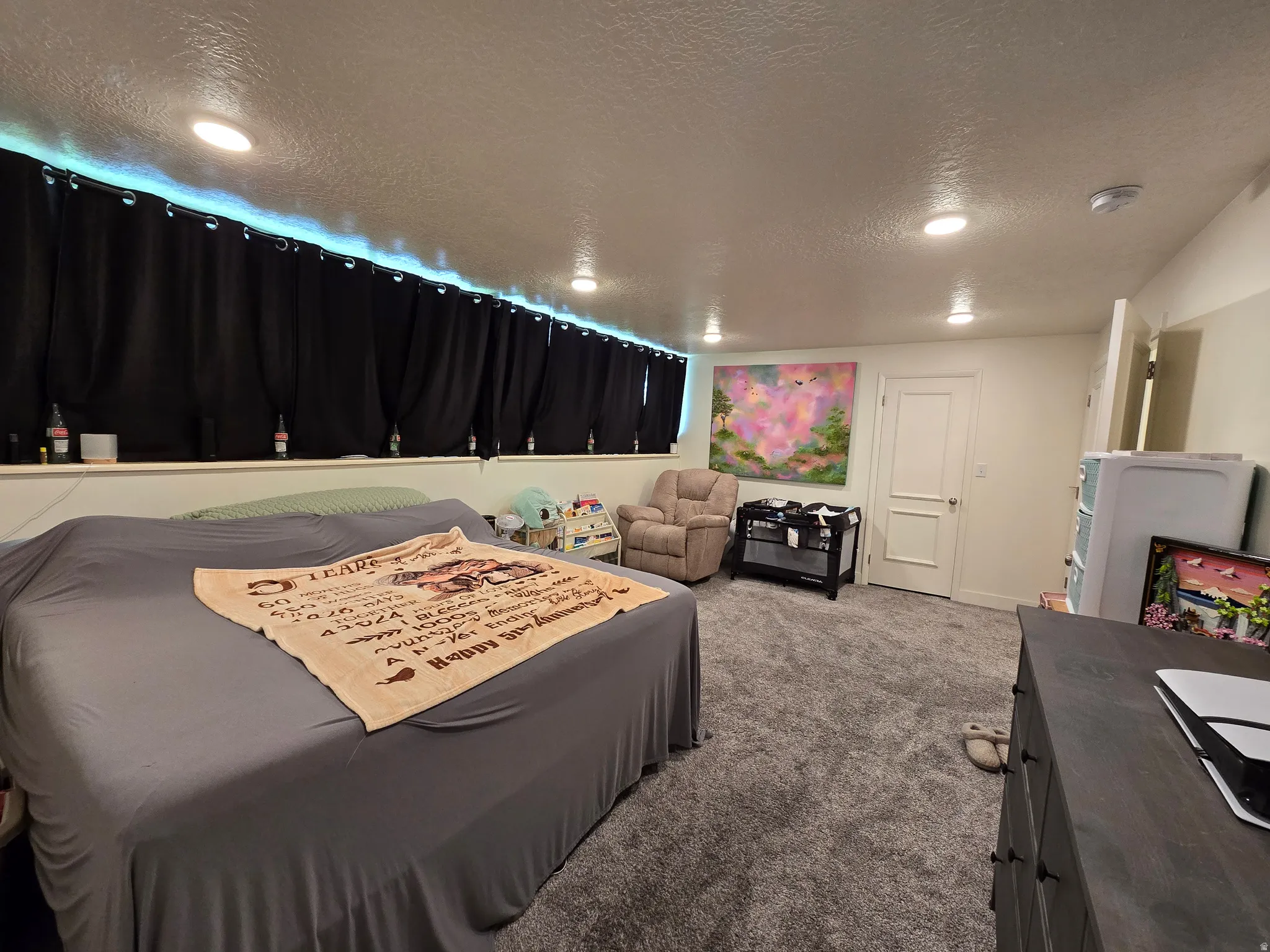 Spacious room featuring recessed lighting, plush grey carpeting, a white interior door, and a built-in shelf
